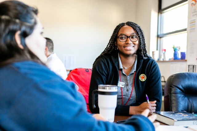 City Year AmeriCorps member with students in school