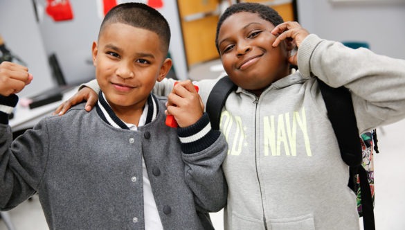 Two elementary students pose for the camera