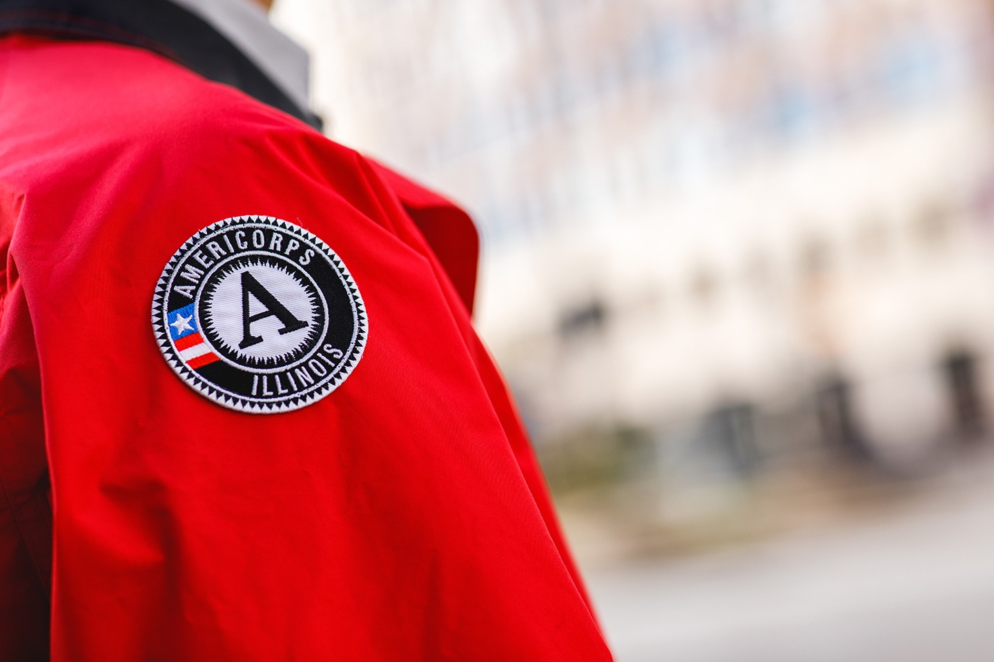 A close up of the AmeriCorps logo patch on the City Year jacket.