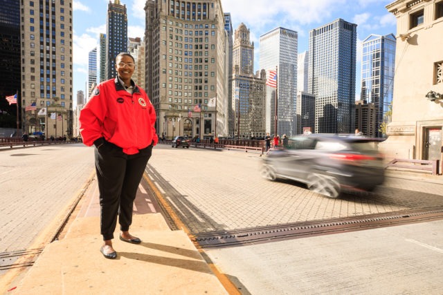 An AmeriCorps member stands in the heart of the city.