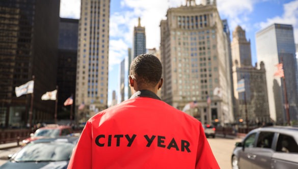 An AmeriCorps member looks ahead at the city skyline.