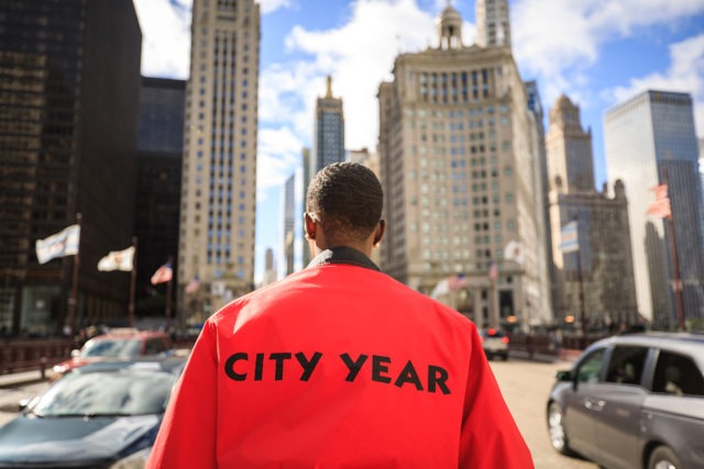 An AmeriCorps member looks ahead at the city skyline.