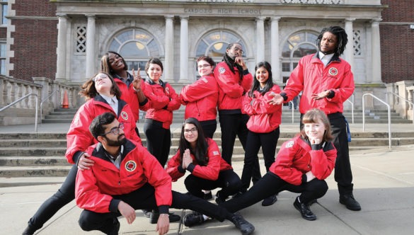 A team of AmeriCorps member each strike a unique, silly pose.