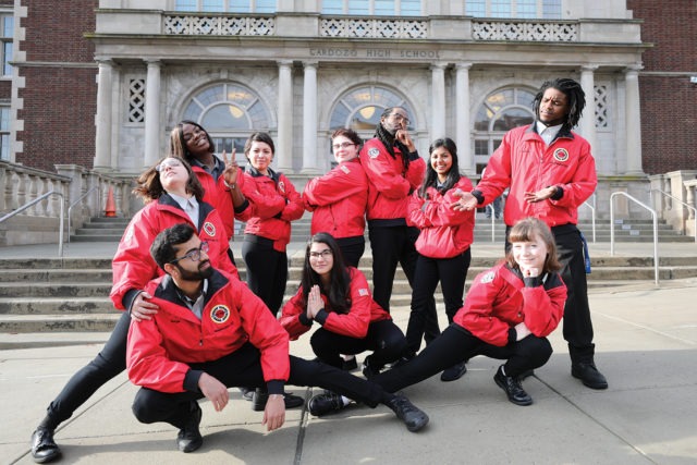 A team of AmeriCorps member each strike a unique, silly pose.