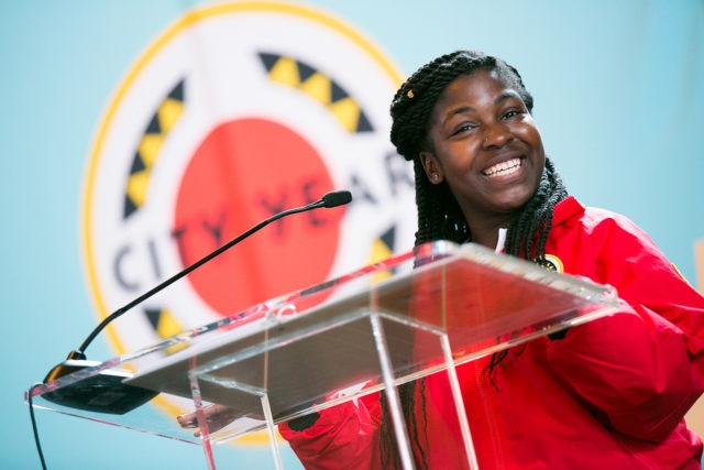 AmeriCorps member smiling at a podium