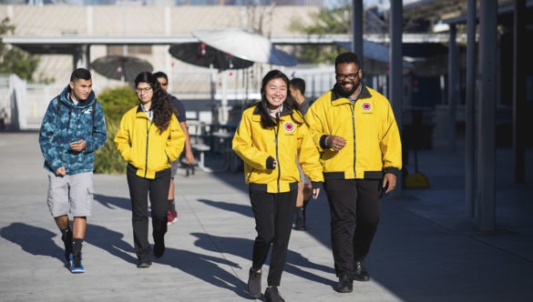 A team of three AmeriCorps members walk away from the playground