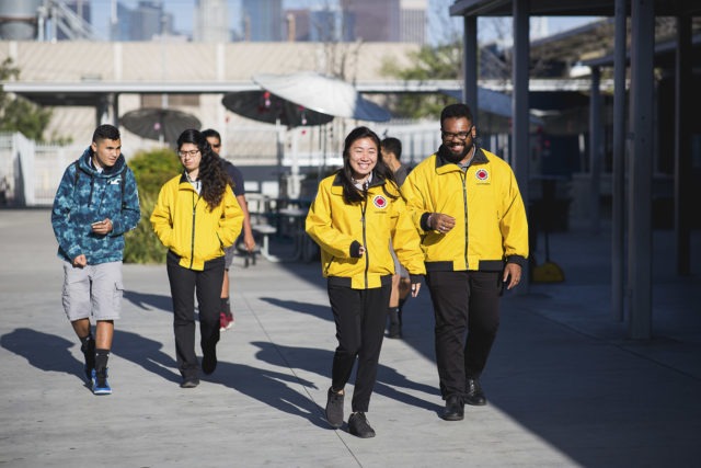 A team of three AmeriCorps members walk away from the playground