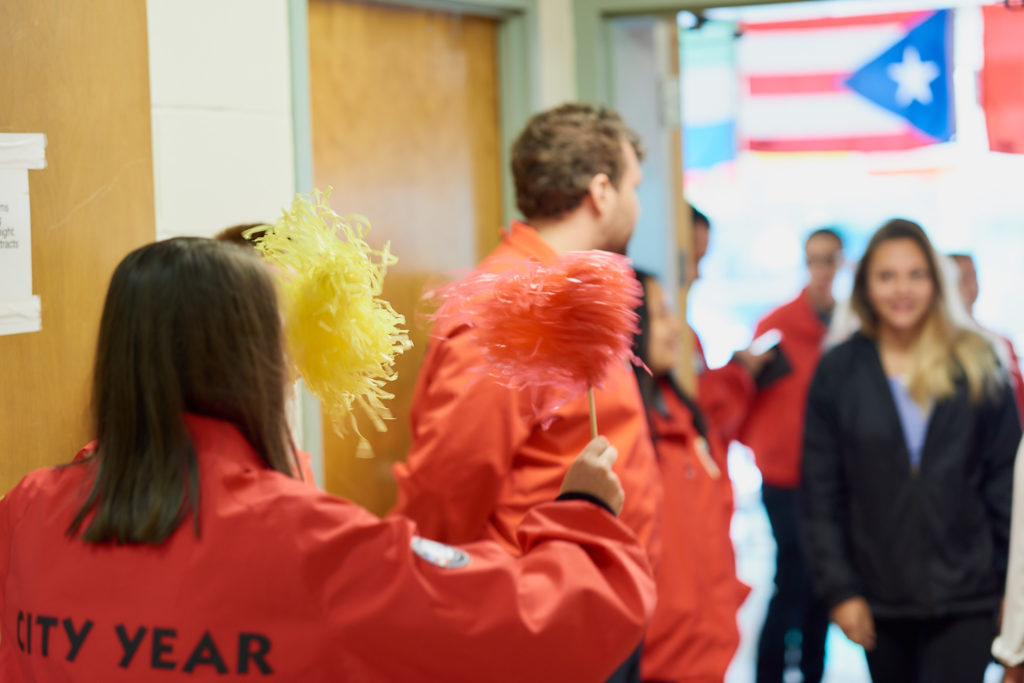 AmeriCorps member waves pompoms at Opening Day