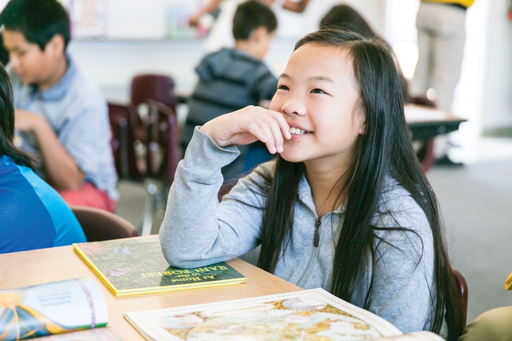 a student is smiling during a reading group