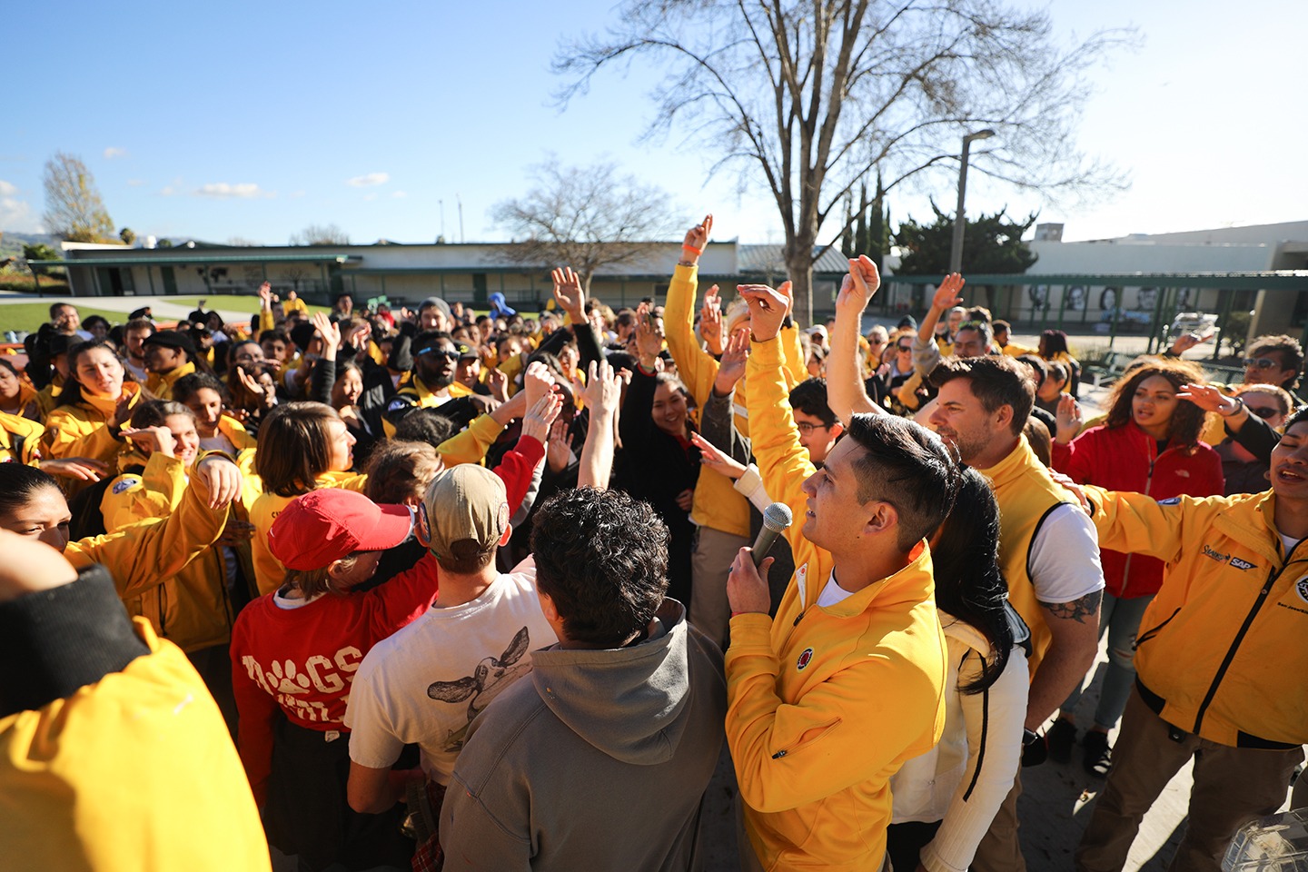 A group of City Year AmeriCorps members and school staff gather together for a spirit break.