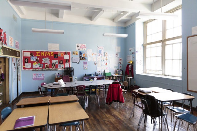 A classroom with desks in small groups.