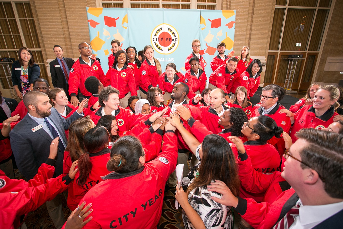 A group of City Year AmeriCorps members and staff doing a spirit break
