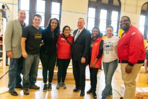 A line of eight volunteers and corpsmembers pose together