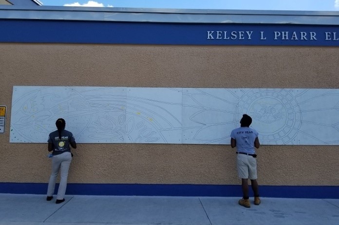 Team Care Force traced a mural in preparation for the service day