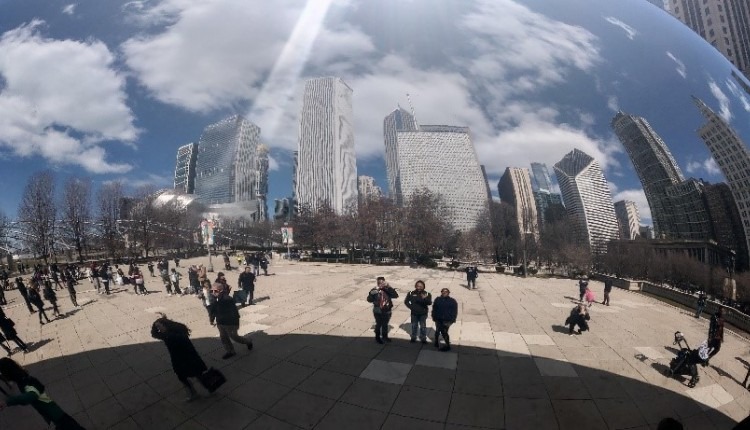 Three Care Force members take their picture reflecting in the famous Chicago bean.