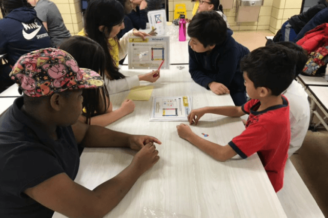 City Year AmeriCorps members work with students in STEM