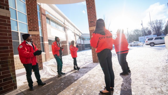 City Year AmeriCorps members welcome students