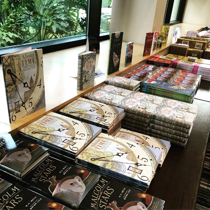 piles of picture books line a table