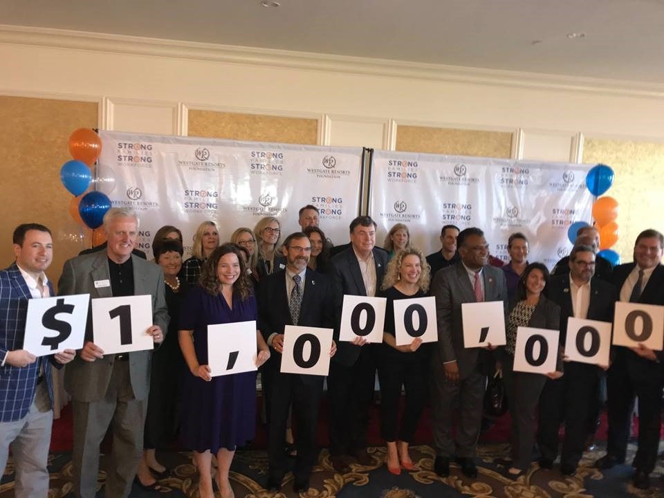 Westgate employees hold a sign that says $1,000,000 to signify this milestone