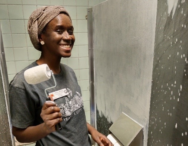 City Year’s Farida Jawando, Regional Recruitment Coordinator for the Northeast, using a roller to prime during her first project with Care Force.  