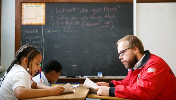 City Year AmeriCorps member tutoring students