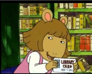 D.W. from Arthur holds a library card in her hands for the first time.