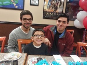 Ortiz with his two brothers, Javy and Henry