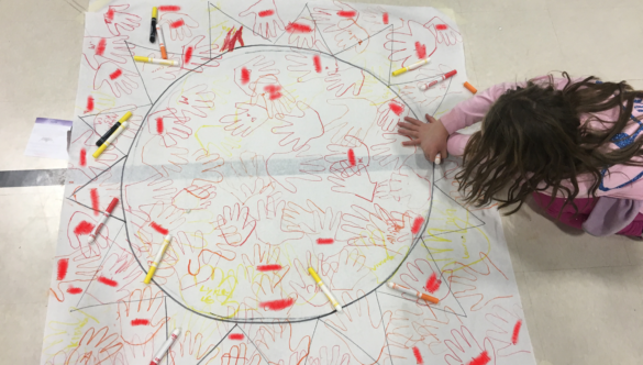 Students add their handprints to the sun at McDonough's literacy night