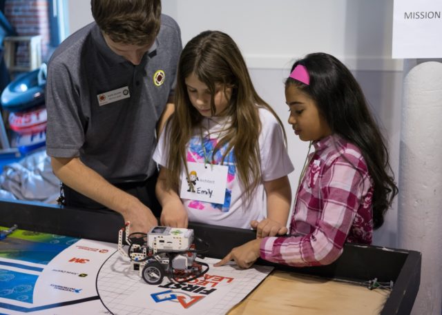 Students work with a City Year to program their robot to complete challenges