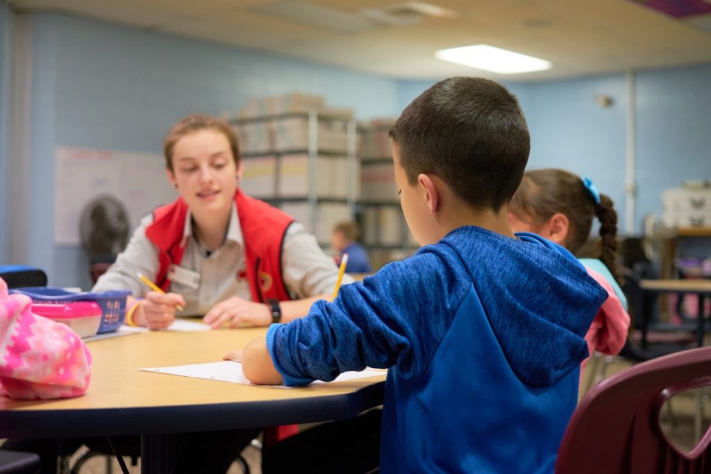 Miko Crosby works with students in their literacy group