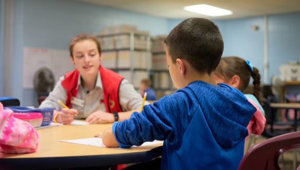 Miko Crosby works with students in their literacy group