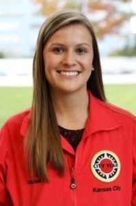 Headshot of Senior AmeriCorps Member Delaney Pummill smiling in the iconic red jacket.