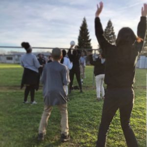 A City Year americorps member plays volleyball with students