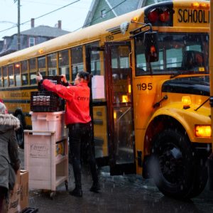 Abby Cozzolino loads a bus with lunches