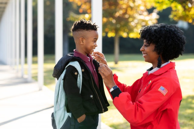 City Year AmeriCorps member with student