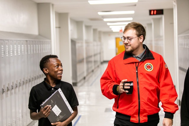 City Year AmeriCorps member with student at school