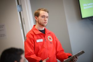 Senior AmeriCorps Member Doug Peters wearing the iconic City Year bomber and name tag.