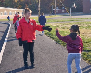 Kathryn Locke greets students as they arrive at school