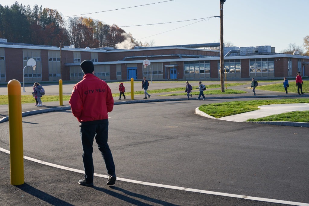 Service Leader Tyler Judge waits for students as they arrive at school