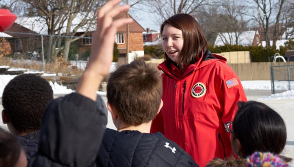 A corps member runs games during recess to help kids cooperate and have fun