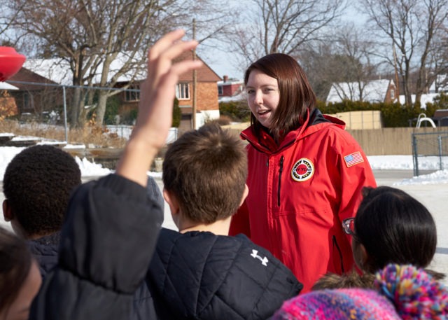 A corps member runs games during recess to help kids cooperate and have fun