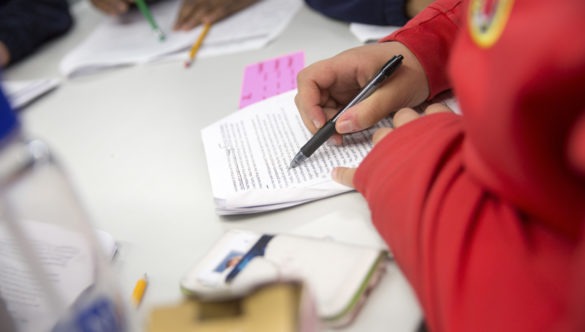 City Year AmeriCorps member tutoring students in ELA