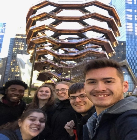 Team Care Force poses in front of The Vessel at Hudson Yards in New York.