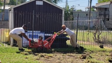 Two Civic Engagement AmeriCorps Members use sod cutter.