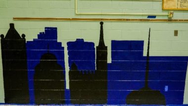 Mural of the Milwaukee skyline painted in blue and black.