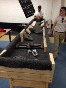 Care Force ACMs finish up a carpet ball set that was made as part of a service event.