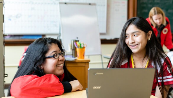 City Year AmeriCorps member with student at school