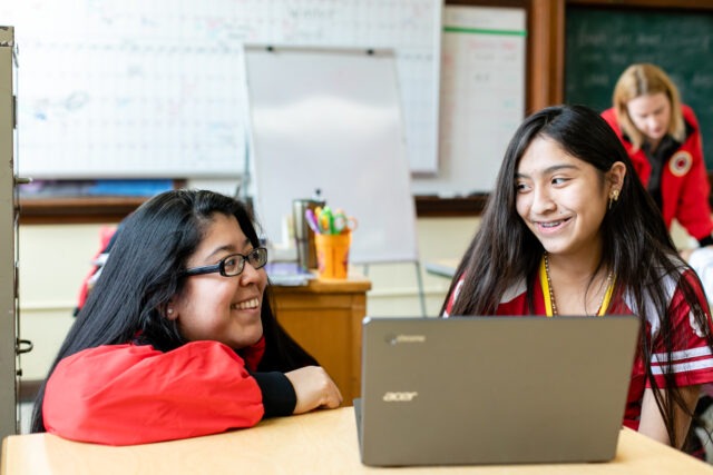 City Year AmeriCorps member with student at school