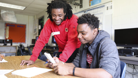 City Year AmeriCorps member tutors student