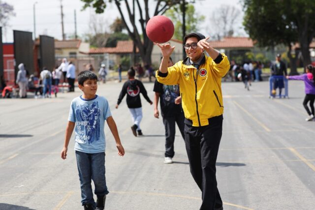 City Year AmeriCorps member with student